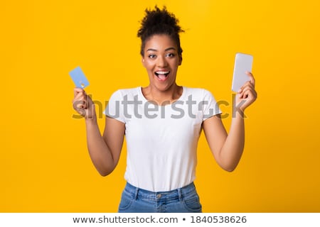 Zdjęcia stock: Excited Happy African Woman Posing Isolated Over Yellow Background Using Mobile Phone Holding Credit