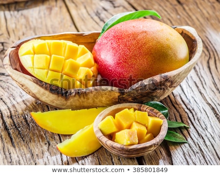 Stockfoto: Mango Fruit And Mango Cubes On The Wooden Table