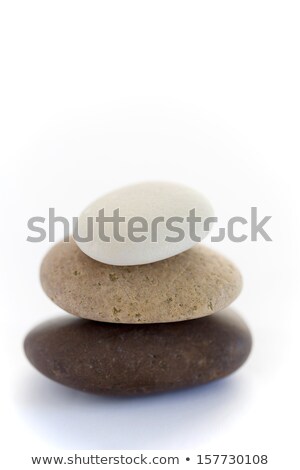 Foto stock: Piled Up Pebbles On A White And Brown Background