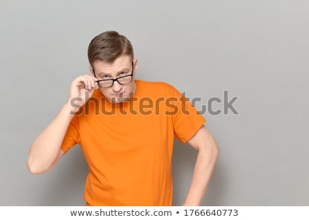 Stockfoto: Doubtful Man Peering Over His Glasses