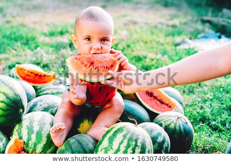 Foto d'archivio: Infant Baby With A Melon