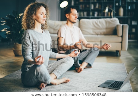 Foto stock: Middle Aged Doing Meditation Lotus Pose