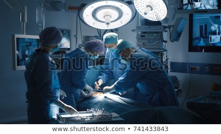 Stok fotoğraf: Surgeons Performing Operation In Operation Theater