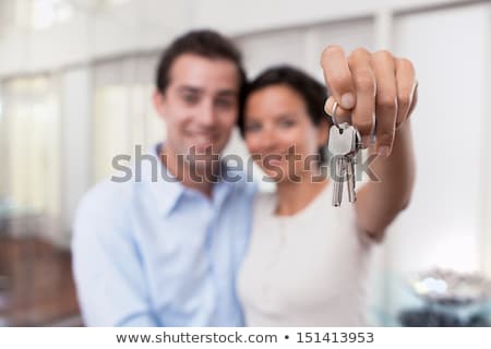 Stockfoto: House Keys In The Female Hand On A White Background