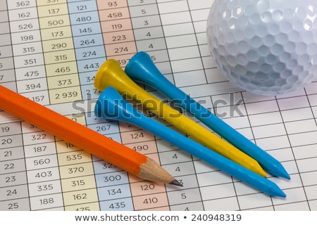 Foto d'archivio: Golf Equipments Lying On A Golf Score Card