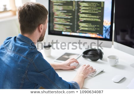 Stock photo: Back View Of Modern Programmer Sitting And Writing Code