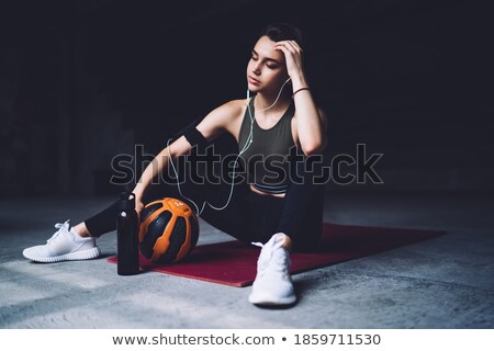 Stock photo: Young Pretty Sportswoman In Earphones Resting