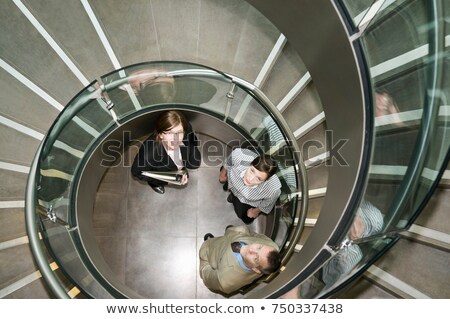 ストックフォト: Business Trio In A Spiral Stairwell