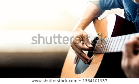 Stock fotó: Guitarist Playing Acoustic Guitar