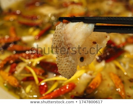 Foto d'archivio: A Piece Of Fish Meat In Chopsticks