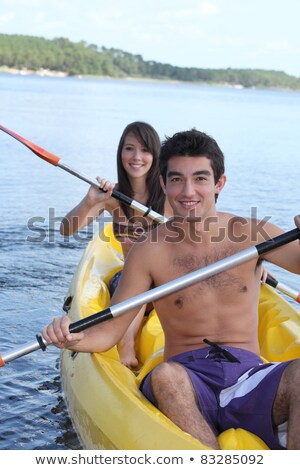 Stockfoto: Young Couple Kayaking Down A River