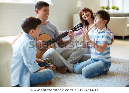 [[stock_photo]]: Young Man Playing The Guitar And Whistling