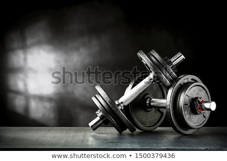 Stockfoto: Man Lifting Dumbbell In Gym