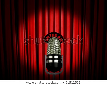 Foto stock: Retro Microphone On Air Over Red Curtains