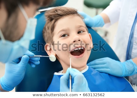 Stock fotó: Female Dentist Examining Boys Teeth