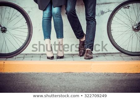 Foto d'archivio: Young Couple With A Bicycle Opposite City
