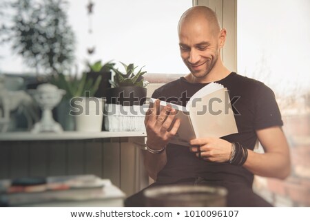 ストックフォト: Young Man Enjoying A Great Book