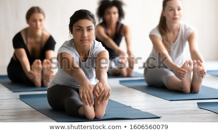 Foto stock: Young Fitness Lady Stretching Exercises