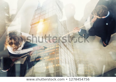 Foto stock: Rival Business Man And Woman Compete For The Command By Pulling The Rope Double Exposure