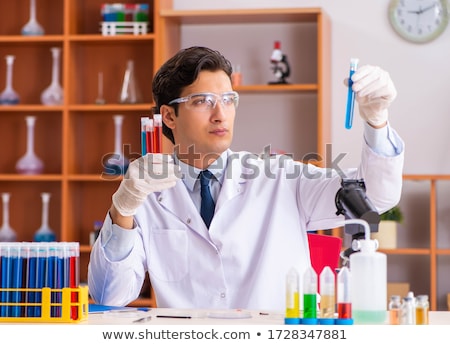 Stok fotoğraf: Young Handsome Biochemist Working In The Lab