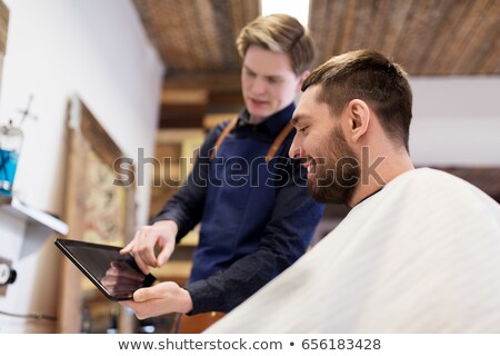 Stock foto: Barber Showing Tablet Pc To Client At Barbershop