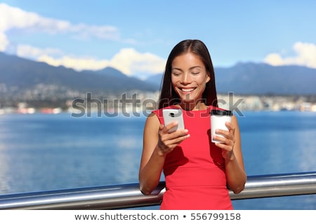 Businesswoman Drinking Coffee Using Mobile Phone App In City To Play Video Games Or Text Sms Online Stockfoto © Maridav