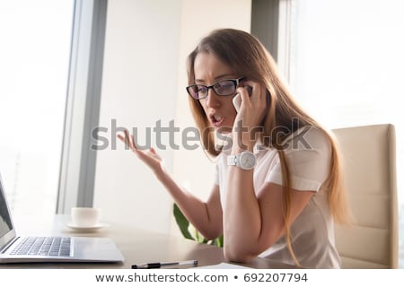 Foto stock: Angry Woman Making A Phone Call