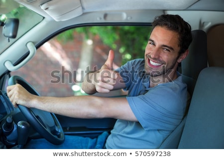 Foto stock: Business Man Sitting While Showing The Thumbs Up Gesture