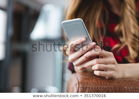 Foto stock: Close Up Of Smartphone Used By Young Blonde Woman