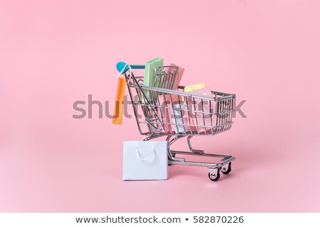 Stok fotoğraf: Miniature Shoppers With Shopping Cart