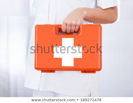 Foto stock: Young Caucasian Doctor Holding First Aid Box