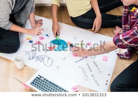 Stok fotoğraf: Three People Writing Observations During Brainstorming Session