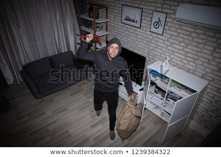 Сток-фото: Thief With Crowbar And Sack Standing In House