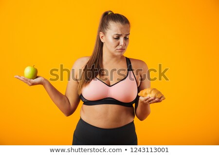 Zdjęcia stock: Image Of Displeased Chubby Woman In Tracksuit Holding Apple And