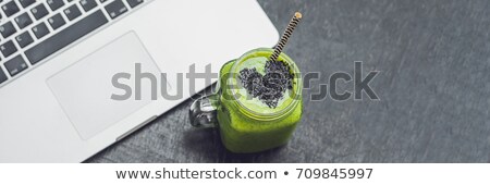 [[stock_photo]]: Banner Fresh Green Smoothie With Banana And Spinach With Heart Of Sesame Seeds And A Laptop Love For