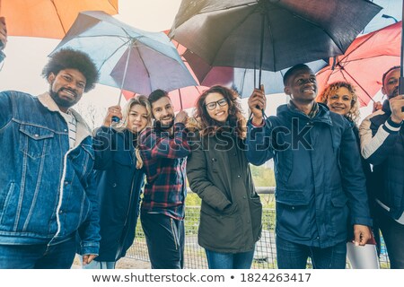 ストックフォト: Friends Making The Best Of Rain And Bad Weather