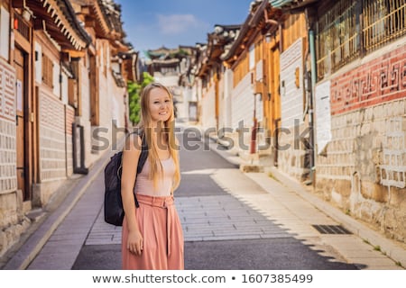 Foto stock: Young Woman Tourist In Bukchon Hanok Village Is One Of The Famous Place For Korean Traditional House