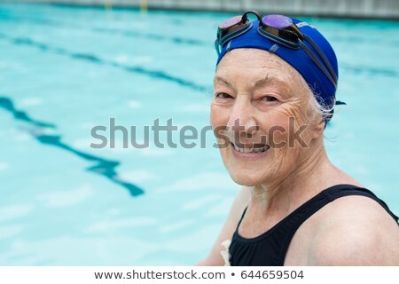 Stock fotó: Senior Woman Sitting By The Pool