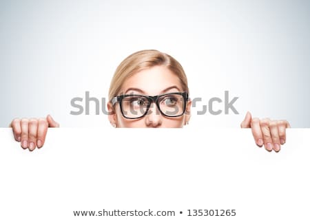 Woman Looking Over Empty White Board Isolated On White Foto d'archivio © doodko