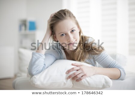 Zdjęcia stock: Smiling Woman With Cushions On Couch