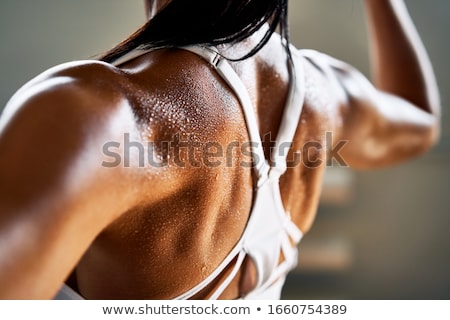 Foto d'archivio: Close Up Of Athletic Woman Flexing Her Biceps