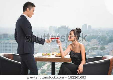 Foto stock: Young Asian Couple Drinking Wine In Restaurant