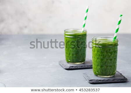 Foto stock: Spinach Smoothie Healthy Drink In Glass Jar On Grey Stone Background