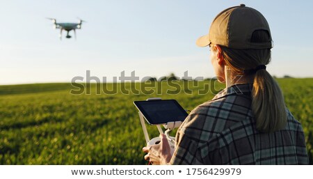 Stockfoto: Female Farmer Using Tablet In Wheat Crop Field