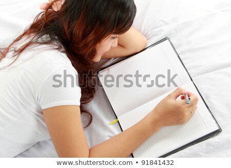 Сток-фото: Casual Adult Female Writing Notes On Notepad Paper