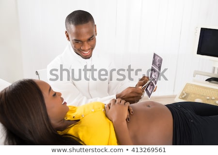 Zdjęcia stock: Doctor Showing Medical Report To Pregnant Woman