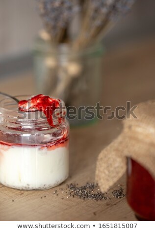 Foto d'archivio: Layered Yogurt Homemade Dessert With Ripe Strawberries Chia Pudding In Glass On A Wooden Backgroun