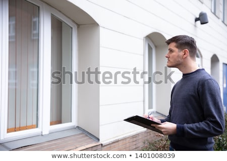 ストックフォト: Service Man Examining Closed Door