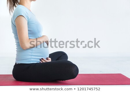 Stock photo: Woman Sitting On A Mat In A Gym