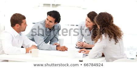 [[stock_photo]]: Four Engineers Discussing About A New Project Around A Table